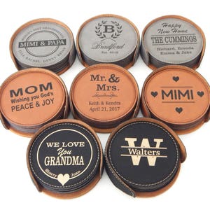 May include: Set of ten leather coasters with personalized engravings. The coasters are in various colors, including brown, black, and gray. The engravings include names, dates, and messages.