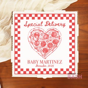 May include: A square white cardboard pizza box featuring a red and white checkered border. The center displays a red line drawing of a heart-shaped pizza with the text Special Delivery, BABY MARTINEZ, and the date December 2025 printed in red.