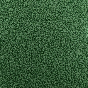 K&ouml;nnte beinhalten: Nahaufnahme eines dunkelgr&uuml;nen, flauschigen Stoffes. Der Stoff hat eine weiche, pl&uuml;schige Textur.