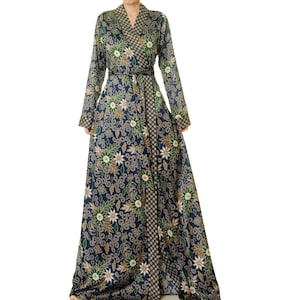 May include: A long, navy blue robe with a floral print in shades of green, white, and gold. The robe has a wrap closure and a sash tie at the waist.
