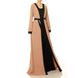 May include: A long, beige and black robe with a black sash. The robe has a ribbed texture and a long, flowing silhouette.