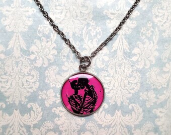 Hot pink kissing skeletons necklace