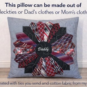 May include: A square gray pillow featuring a central flower-like design made from various red, black, and white patterned neckties. The center circle is black with the word Daddy embroidered in white. Text reads: This pillow can be made out of Neckties or Dad's clothes or Mom's clothes. Created with ties you send and cotton fabric from my shop.