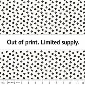 May include: White fabric patterned with small black cat faces. The fabric has the text "Out of print. Limited supply." printed on it. A ruler in inches is at the bottom of the image.