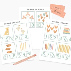 May include: A printable set of four number matching cards with various illustrations, including a dog, ducks, flowers, eggs, chickens, books, crayons, and pencils. The cards have the text "NUMBER MATCHING" at the top and numbers 1 through 10.