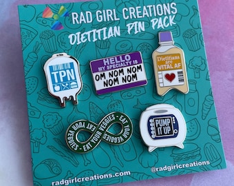 May include: A set of six enamel pins featuring a green infinity symbol with the text "Eat Your Veggies", a white IV bag with the text "TPN", a purple rectangle with the text "Hello My Specialty is Om Nom Nom Nom Nom", a white pump with the text "Pump It Up", a yellow bottle with the text "Dietitians are Vital AF", and a red heart. The pins are on a green and white background with a rainbow design at the top.