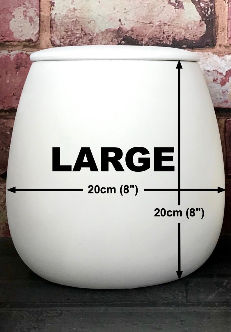 May include: White ceramic planter with the word "LARGE" printed on the front. The planter is 8 inches in diameter and 8 inches tall.