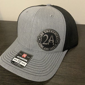 May include: A gray and black trucker hat with a black patch that says "2nd Amendment 2A Come and Take It" in silver lettering.