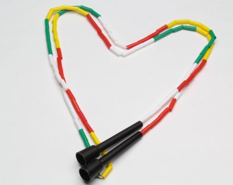 May include: A colorful jump rope with red, white, green, and yellow sections. The rope has black handles.