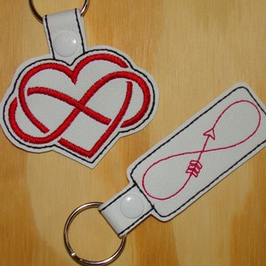 Infinity heart or Infinity arrow embroidered vinyl key fobs.   Red & White!