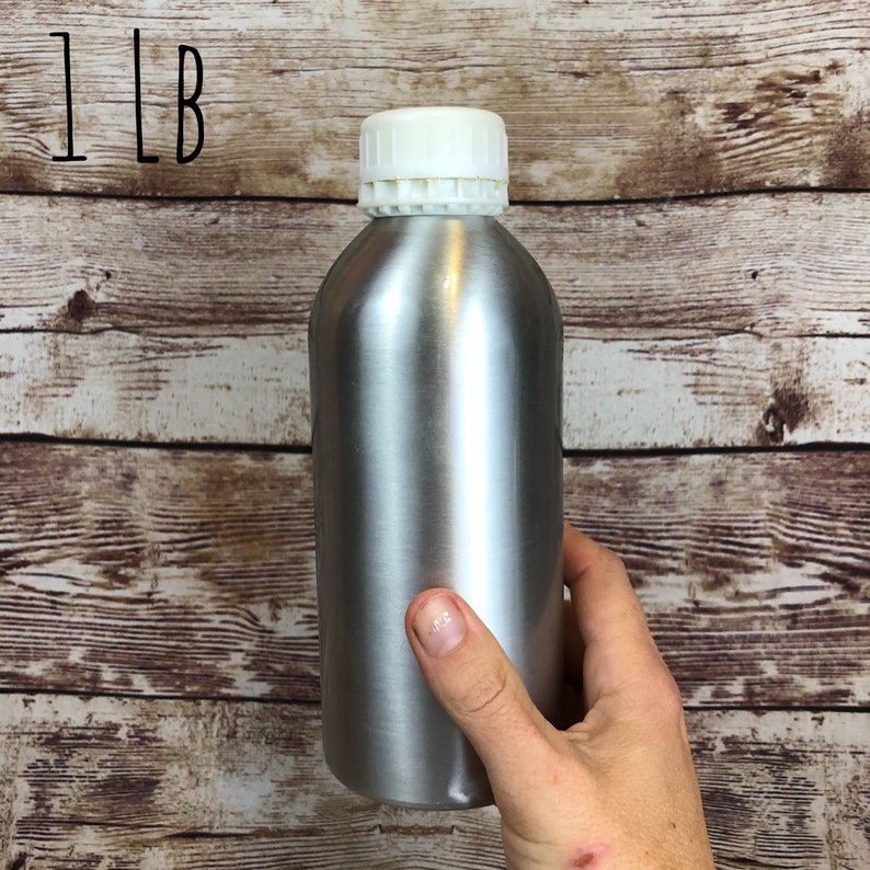 May include: A silver metal bottle with a white lid. The bottle is labeled "1 LB".