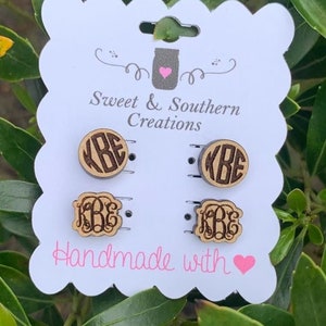 May include: A set of four wooden earrings with the monogram "KBE" engraved on each. The earrings are displayed on a white card with the text "Sweet & Southern Creations" and "Handmade with" followed by a pink heart.