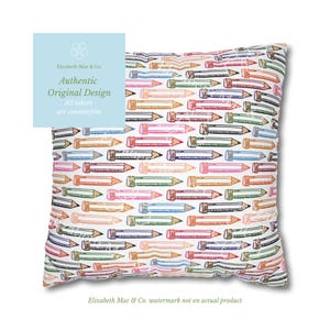 May include: A square throw pillow featuring a repeating pattern of colorful pencils in shades of blue, green, orange, and pink on a white background. The pencils are illustrated with a sketch-like style, showing graphite tips and erasers.