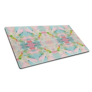 May include: A rectangular glass cutting board featuring a symmetrical abstract pattern with blended brushstrokes in soft pastel pink, light blue, white, and subtle hints of yellow and green, presented in a flat perspective view.