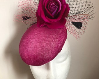 Cerise Sinamay pillbox hat with velvet cerise flower , black and pale pink feathers and black and cerise veiling. Hatinator,Royal Ascot hat