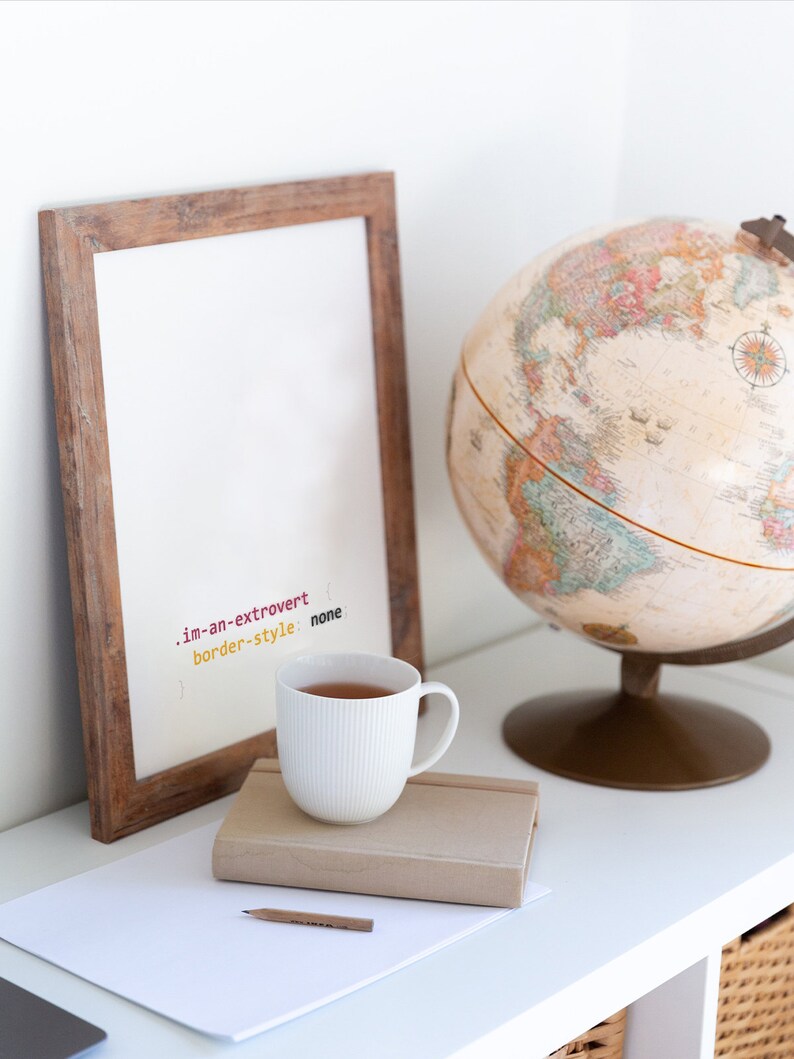 Peut inclure: Une tasse en c&eacute;ramique blanche avec un cadre en bois brun et un globe sur une &eacute;tag&egrave;re blanche. La tasse est remplie d'un liquide brun et le cadre porte le texte ".im-an-extrovert border-style: none" &eacute;crit dessus.