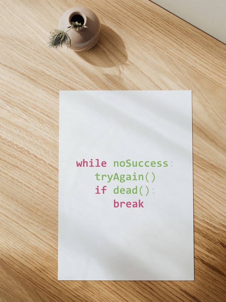 May include: A white sheet of paper with the code "while noSuccess: tryAgain() if dead(): break" written in green and pink.