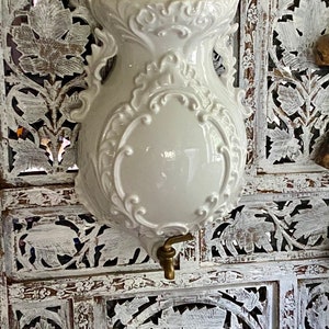 White ceramic wall fountain lavabo cistern