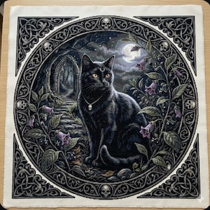 May include: A square cross-stitch embroidery featuring a black cat with yellow eyes and a crescent moon mark on its forehead, wearing a skull pendant. The cat is framed by a circular border with skulls, set against a moonlit path and purple flowers.