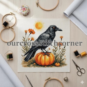 May include: Cross-stitch design featuring a black crow perched on an orange pumpkin, with orange flowers and a yellow sun in the background. The text "ourcrossstitchcorner" is displayed. The design is surrounded by embroidery supplies.