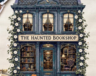 May include: A cross-stitch embroidery of a two-story building titled The Haunted Bookshop. The dark blue structure features large windows, bookshelves, a central door, and white climbing roses on both sides. A small orange pumpkin sits at the base.