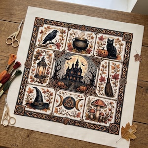 May include: A square fabric panel featuring a multi-paneled cross-stitch design with a central haunted house, surrounded by illustrations of a raven, a cauldron, a black cat, a lantern, a broom, a witch hat, a triple moon symbol, and mushrooms.