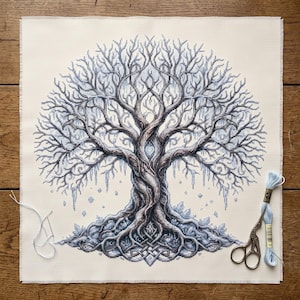 Può includere: Un pezzo quadrato di tessuto color crema con un dettagliato disegno a punto croce di un grande albero senza foglie con rami e radici intrecciati in tonalità di blu, grigio e marrone, accompagnato da un ago, filo e forbici.