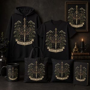 May include: A collection of black merchandise including a hoodie, t-shirt, tote bag, mug, pillow, framed print, and notebook. Each item features a graphic of a moth with a skull, a dagger, and floral elements with the text FRAGILE, BUT SHARP.