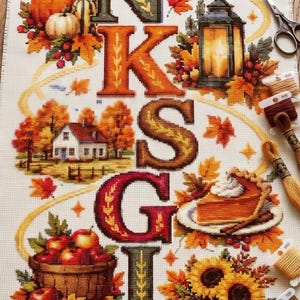 May include: A vertical cross-stitch fabric panel featuring the word THANKSGIVING spelt out in large, decorative letters. The design is adorned with autumn-themed motifs including a turkey, pumpkins, a cornucopia, a lantern, a house, pie, and sunflowers.