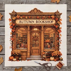 May include: A cross-stitch embroidery on white fabric depicting a storefront with the text AUTUMN BOOKSHOP. The shop features brown wooden architecture, orange and yellow autumn leaves, pumpkins, and stacks of books in the display windows.