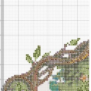 May include: A cross-stitch pattern chart on a white grid background, labeled 14 ct Aida Designed by AutumnAndrea. The chart features a partial design with various symbols in shades of green, brown, and blue, with page 2 and 2025 printed.
