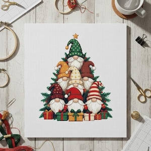 May include: A cross-stitch of a Christmas tree made of gnomes. The gnomes wear hats in various colors, including green, red, and yellow. The tree is decorated with small presents at the base and a gold star at the top.