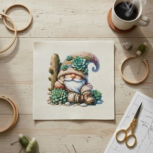 May include: A cross-stitch project featuring a gnome with a white beard, wearing a hat adorned with succulents, and sitting next to a cactus. The scene includes embroidery hoops, scissors, thread, and a cup of coffee on a wooden surface.