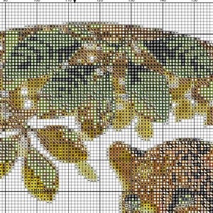 May include: A cross-stitch pattern featuring a detailed floral design. The pattern uses a grid of small squares in shades of green, yellow, and brown, creating a textured, pixelated effect. The design appears to be a close-up of leaves and flowers.