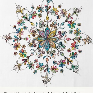 Pode incluir: Um padrão de ponto cruz de mandala floral colorido em tecido branco. O design apresenta um arranjo simétrico de flores e folhas em várias cores, incluindo azul, amarelo, rosa e verde. O padrão mede 56 cm x 56 cm.