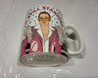 I'm Still Standing (Flaming Gay Male)" Ceramic Coffee Mug, 13 oz, TheFound.com, Chicago, Ill.