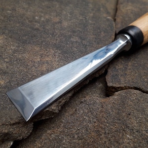 Forged carpentry chisel. Flat chisel Fishtail. Wood carving tool.