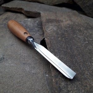 Forged V-chisel. Woodworking tool. woodcarving chisel