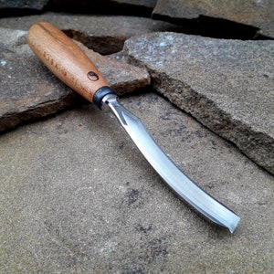 Forged curved V-shaped chisel. Woodworking tool. wood carving chisel