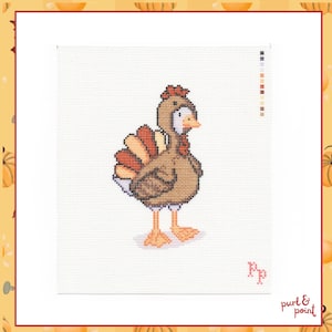 May include: A cross-stitch pattern on white Aida cloth featuring a brown turkey with orange and yellow tail feathers, a red wattle, and orange feet. The design includes a colour key on the right side and the letters Rp in the bottom right corner.