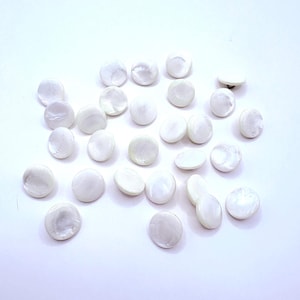 May include: A set of three ceramic mugs with a speckled, matte finish. The mugs are in shades of cream, light gray, and dark gray. Each mug has a simple, modern design and a rounded handle.