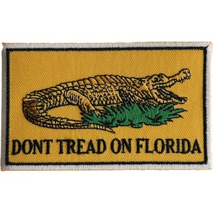 May include: A yellow embroidered patch with a green alligator and the text "DONT TREAD ON FLORIDA".