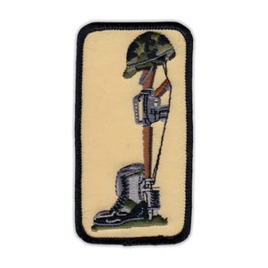 May include: A black and yellow embroidered patch with a soldier's helmet, rifle, and boot in a memorial pose.