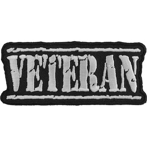 May include: Black and white embroidered patch with the word "Veteran" in white lettering.