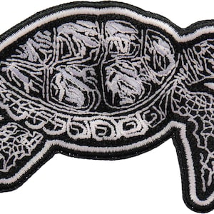 May include: Black and white embroidered iron-on patch of a sea turtle with a detailed shell design.
