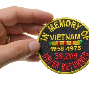 May include: Black embroidered patch with yellow stitching. The patch reads "In Memory of Vietnam 1959-1975 58,209 Never Returned".
