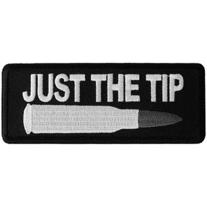 May include: Black embroidered patch with white text that reads "JUST THE TIP" and a white bullet underneath.