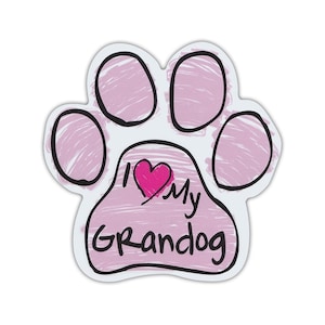 May include: A paw-shaped sticker with a pink interior and black outline. The text "I ❤️ My Grandog" is written in black, with a pink heart replacing the word "love". The sticker is designed to be placed on a smooth surface.