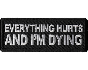 May include: Black embroidered patch with white text that reads "Everything Hurts And I'm Dying."