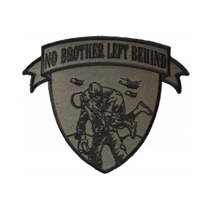 May include: A green embroidered patch with a black outline. The patch features a soldier carrying another soldier on their back. The text "No Brother Left Behind" is on a banner above the soldiers.